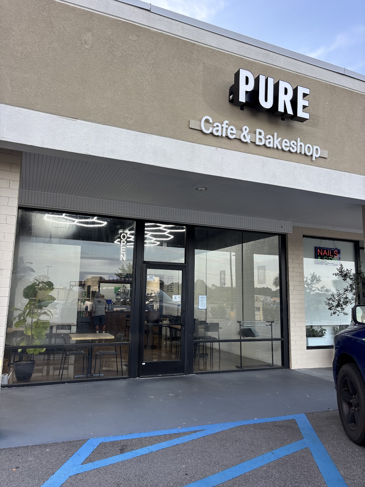 Exterior entrance and sign for Pure Cafe and Bakeshop in Beaufort